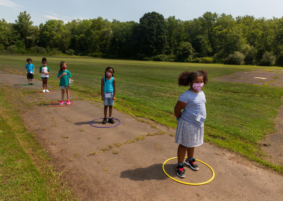 Children line up for school at Wesley Elementary in Middle­town, Conn., on July 20 | Gillian Laub for TIME