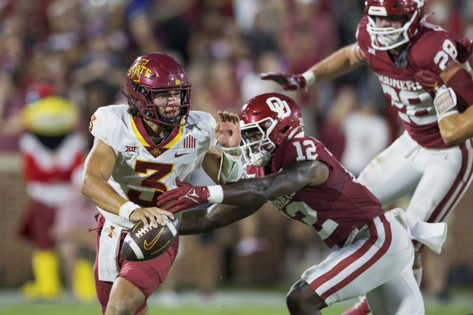 Oklahoma defensive back Key Lawrence (12) pressures Iowa State quarterback Rocco Becht (3) during the first half of an NCAA college football game Saturday, Sept. 30, 2023, in Norman, Okla. (AP Photo/Alonzo Adams)