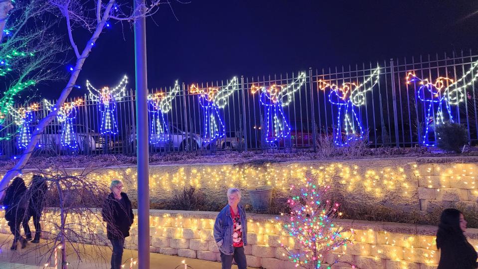 Attendees walk through the Amarillo Botanical Gardens  Thursday during its Christmas in the Garden event.