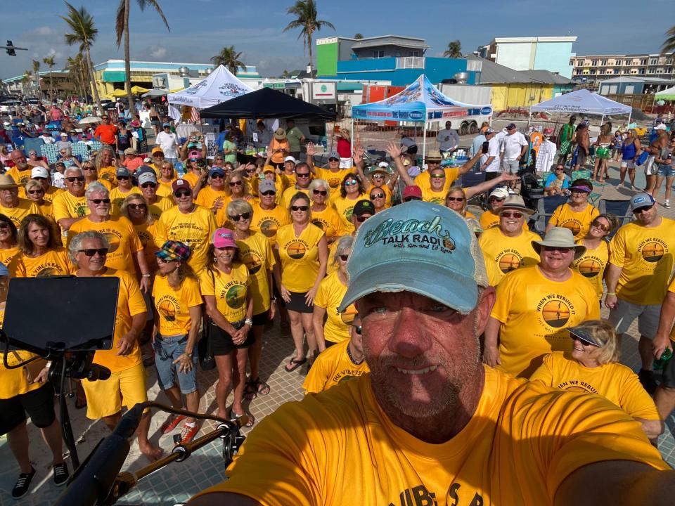 Beach Talk Radio creator Ed Ryan takes a group selfies during a charity event to helps those on Fort Myers Beach impacted by Hurricane Ian.