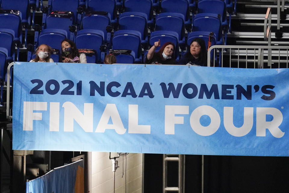 FILE - Fans watch from the stands during the first half of the championship game between Stanford and Arizona in the women's Final Four NCAA college basketball tournament in San Antonio, in this Sunday, April 4, 2021, file photo. A law firm hired to investigate gender equity concerns at NCAA championship events released a blistering report Tuesday, Aug. 3, 2021, that recommended holding the men's and women's Final Fours at the same site and offering financial incentives to schools to improve their women's basketball programs. (AP Photo/Eric Gay, File)