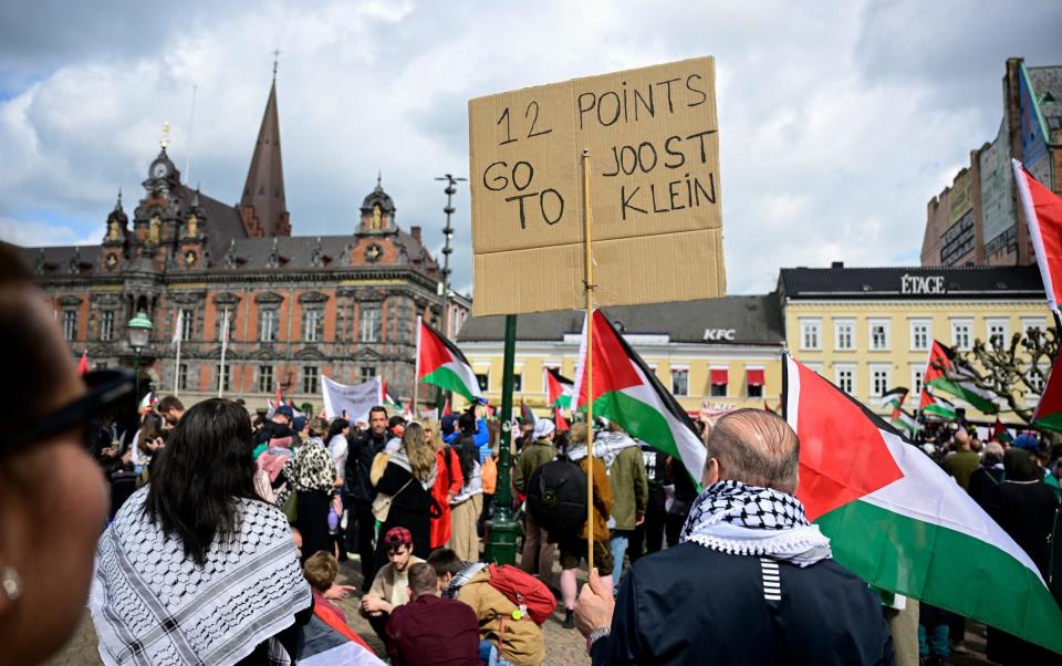 Pro-Palestinian protesters hold up a sign in defence of Joost Klein, the Dutch singer who was disqualified from the competition