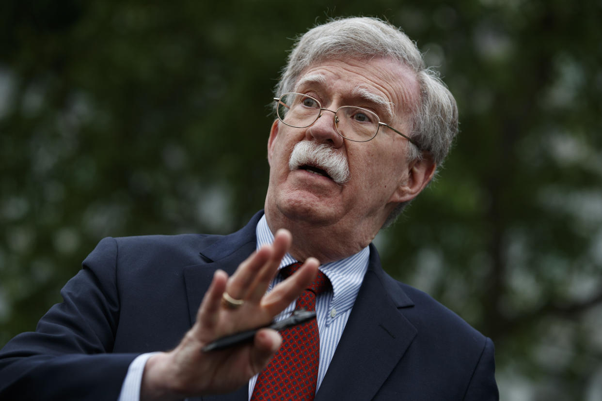 FILE - In this May 1, 2019 file photo, National security adviser John Bolton talks to reporters outside the White House in Washington. Trump says he fired national security adviser John Bolton, says they 'disagreed strongly' on many issues. (AP Photo/Evan Vucci)