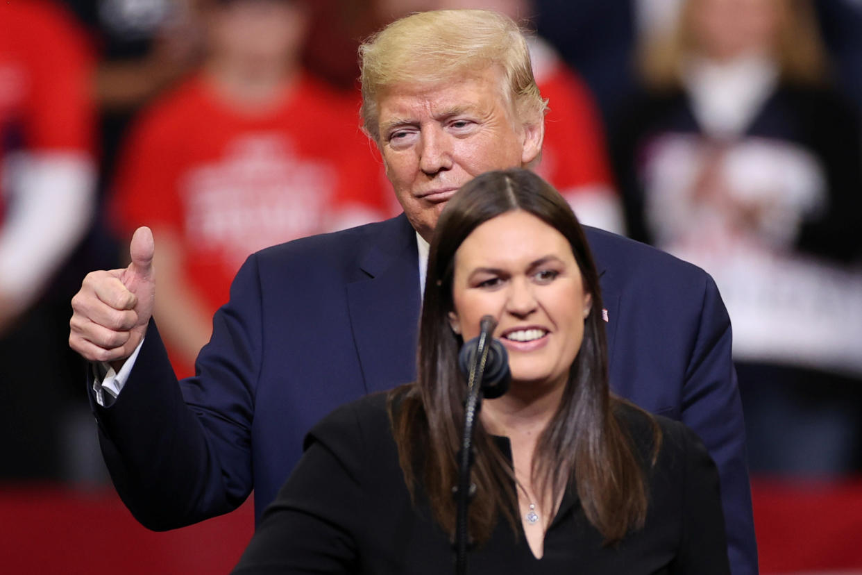 Sarah Huckabee Sanders and then-President Donald Trump at a rally.
