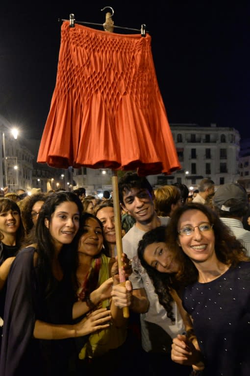 Protesters hold up a skirt during a demonstration against the arrest of two Moroccan women who were stopped by police on their way to work because their outfits were deemed inappropriate