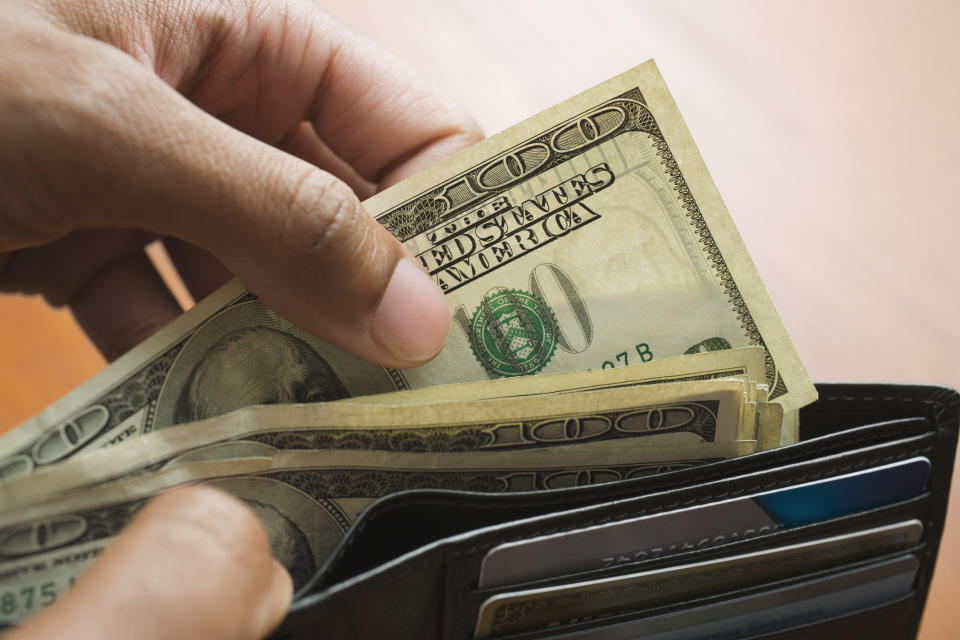 A man pulling out money from his wallet