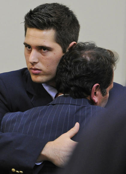 Former Vanderbilt football player Brandon Vandenburg, rear, gets a hug from attorney Albert Perez Jr. after being found guilty, Tuesday, Jan. 27, 2015, in Nashville, Tenn. (AP Photo/The Tennessean, John Partipilo, Pool)