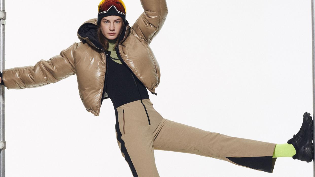 a model kicking while wearing a beige ski jacket and pants by aztech mountain in a roundup of the best womens ski jackets 2023 2024