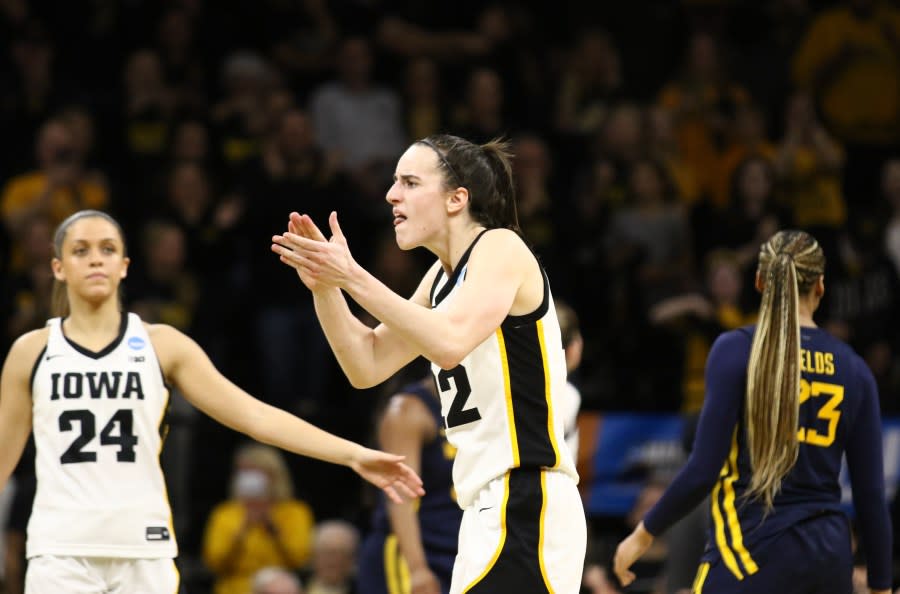 IOWA CITY, IOWA- MARCH 25: Guard <a class="link " href="https://sports.yahoo.com/wnba/players/10154/" data-i13n="sec:content-canvas;subsec:anchor_text;elm:context_link" data-ylk="slk:Caitlin Clark;sec:content-canvas;subsec:anchor_text;elm:context_link;itc:0">Caitlin Clark</a> #22 of the Iowa Hawkeyes taunts the Mountaineer bench as she celebrates after drawing a foul late in the second half against the West Virginia Mountaineers during their second round match-up in the 2024 NCAA Division 1 Women’s Basketball Championship at Carver-Hawkeye Arena on March 25, 2024 in Iowa City, Iowa. (Photo by Matthew Holst/Getty Images)