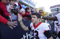 Georgia quarterback Stetson Bennett (13) celebrates with the fans after defeating Georgia Tech an NCAA college football game Saturday, Nov. 27, 2021, in Atlanta. (AP Photo/John Bazemore)