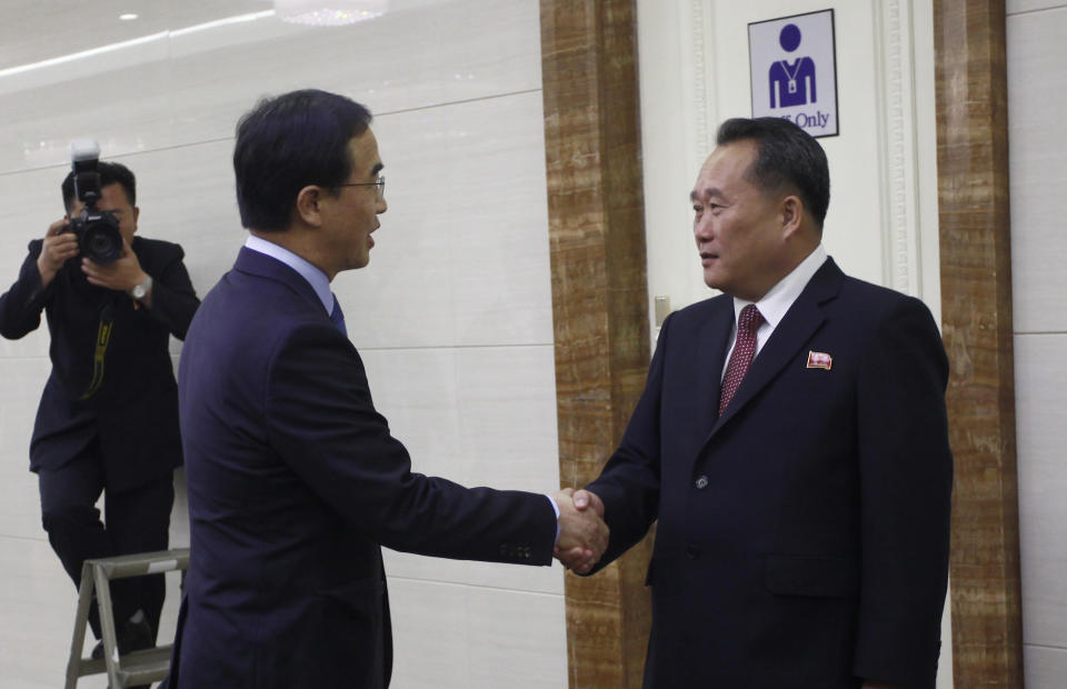 Ri Son Gwon, right, chairman of the North's Committee for the Peaceful Reunification of North Korea, shakes hands with South Korean Unification Minister Cho Myoung-gyon at the Pyongyang Airport in Pyongyang, North Korea Thursday, Oct. 4, 2018. The delegation flew to North Korea on Thursday for a joint celebration of the anniversary of a 2007 summit and to possibly hold further peace talks. (AP Photo/Jon Chol Jin)