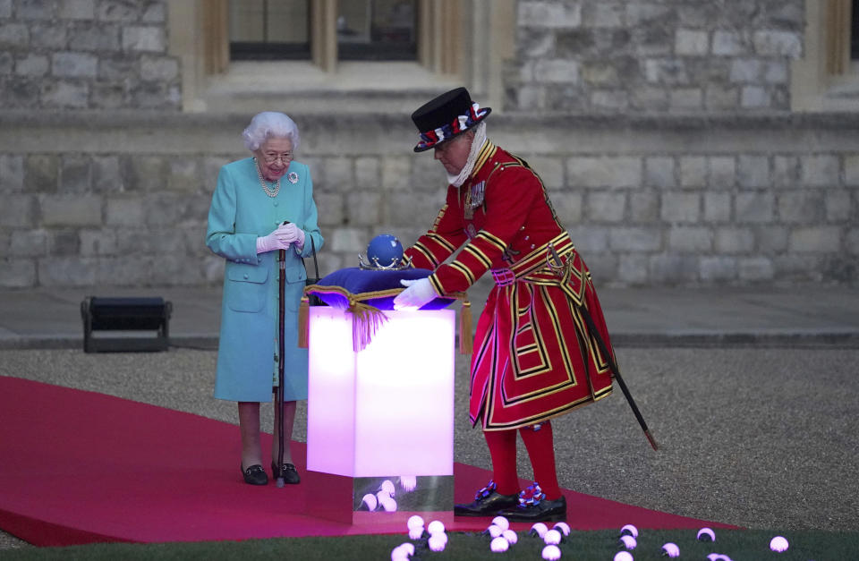 Queen Elizabeth II arrives to symbolically lead the lighting of the principal Jubilee beacon in Windsor, England, Thursday June 2, 2022, on day one of the Platinum Jubilee celebrations. Over 1500 towns, villages and cities throughout the UK, Channel Islands, Isle of Man and UK Overseas Territories will come together to light a beacon to mark the Jubilee. The events over a long holiday weekend in the U.K. are meant to celebrate the monarch’s 70 years of service. (Steve Parsons/Pool via AP)