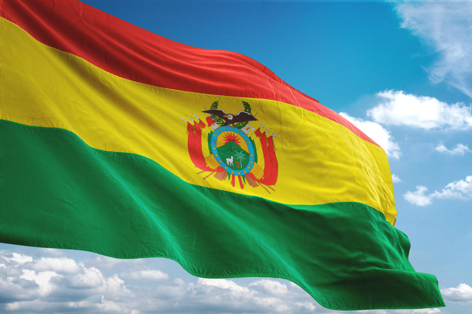 Bolivia flag waving cloudy sky background realistic 3d illustration