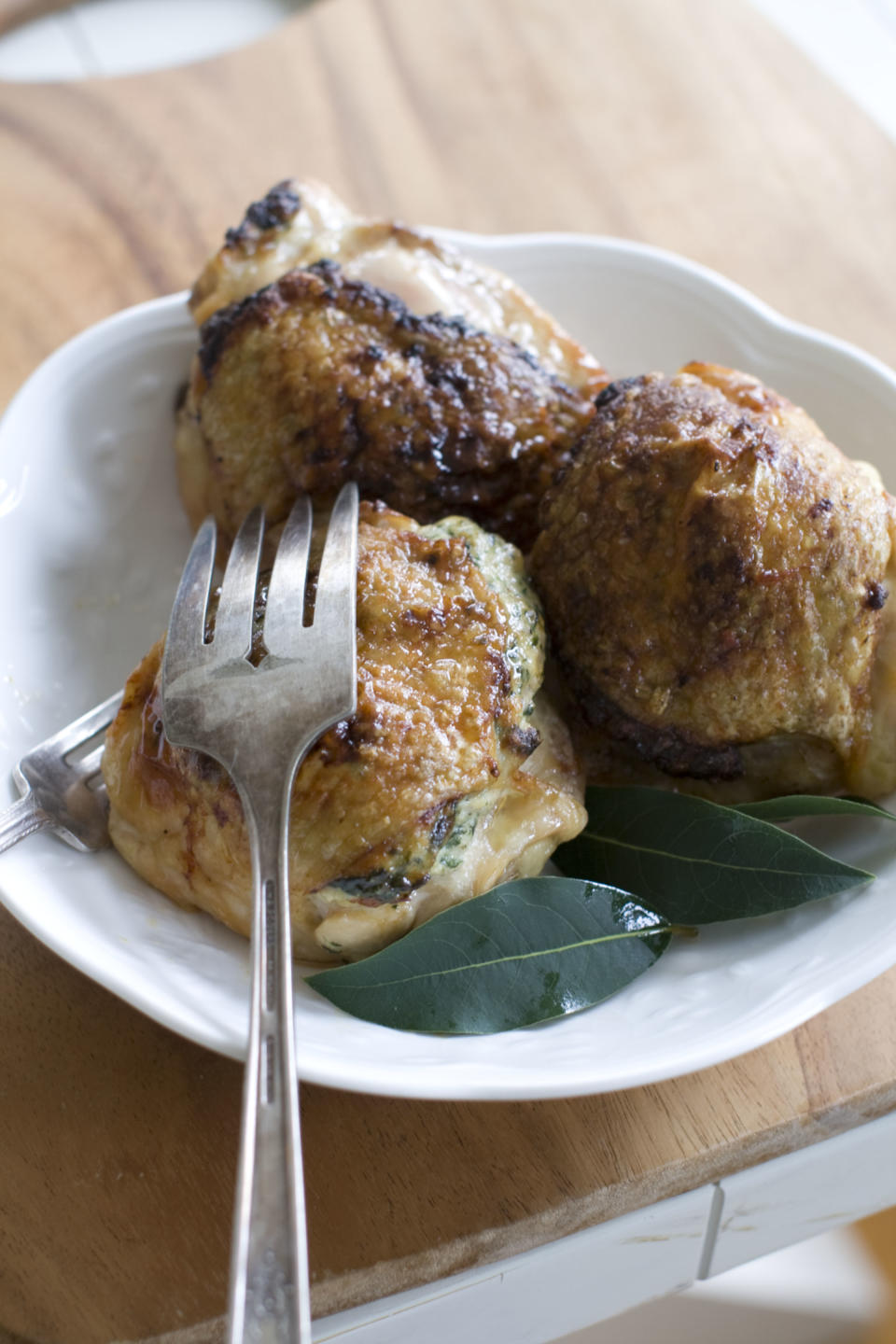 This Nov. 11, 2013 photo shows spinach stuffed chicken thighs in Concord, N.H. (AP Photo/Matthew Mead)