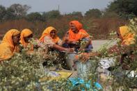 Women wash clothes at a site of a protest against the newly passed farm bills at Singhu border near Delhi