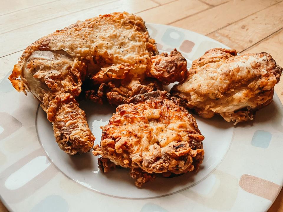 three big pieces of fried chicken on a plate