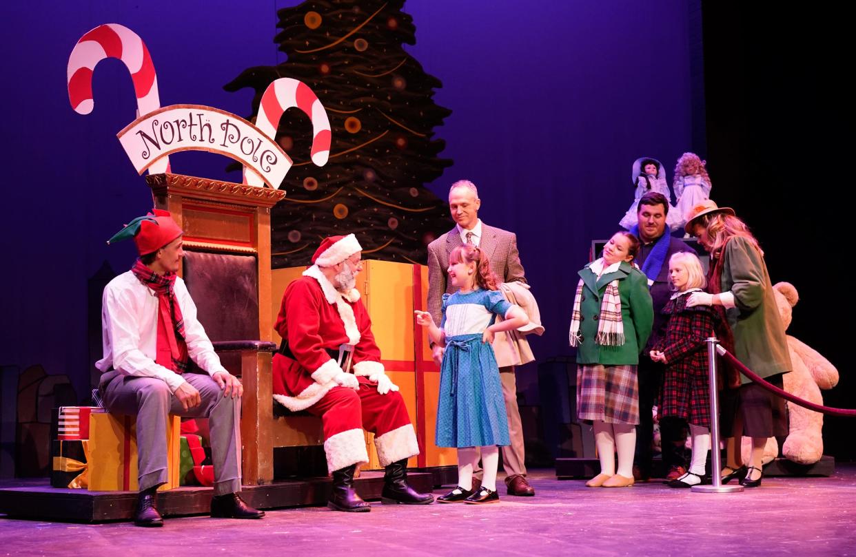 Joe Dennehy as Fred Gailey takes Alayna Brazzil as Susan Walker to meet Santa Claus, played by Mark Hyre, at Macy’s department store in a scene from “Miracle on 34th Street” at the Croswell Opera House.