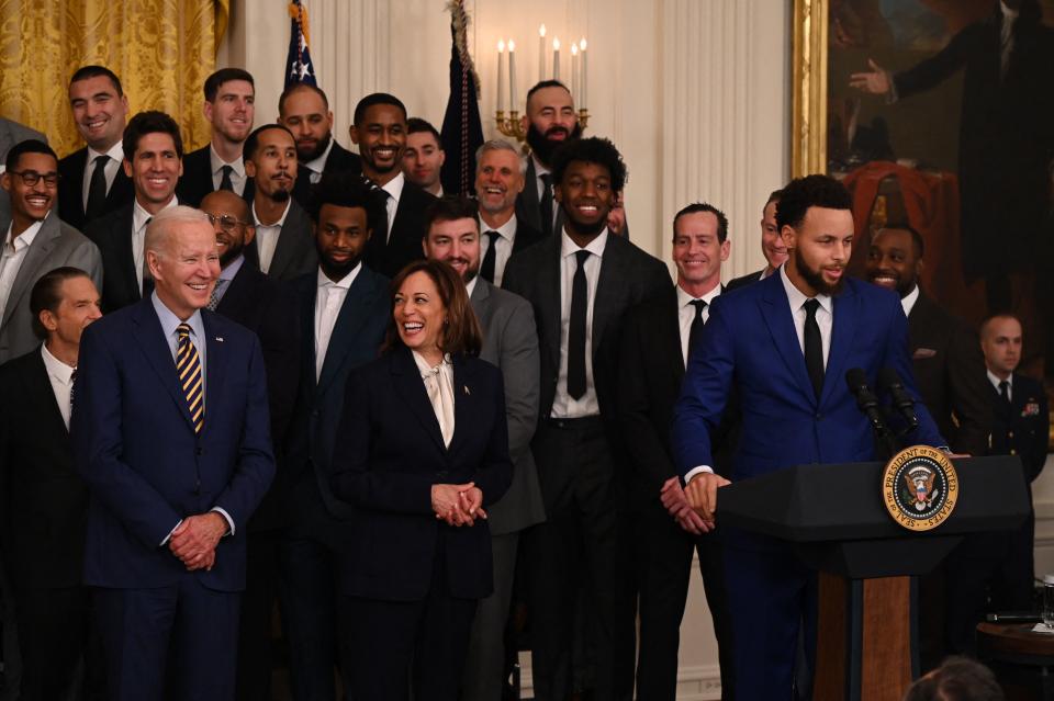 Members of the Golden State Warriors, US Vice President Kamala Harris and US President Joe Biden listen to Golden State Warriors basketball player Stephen Curry speak during a celebration for the Golden State Warriors 2022 NBA championship, in the East Room of the White House in Washington, DC, on January 17, 2023. (Photo by Andrew CABALLERO-REYNOLDS / AFP) (Photo by ANDREW CABALLERO-REYNOLDS/AFP via Getty Images)
