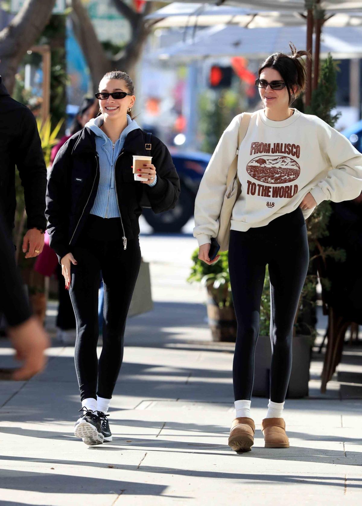 Model Kendall Jenner, wearing red socks, black pants, green top