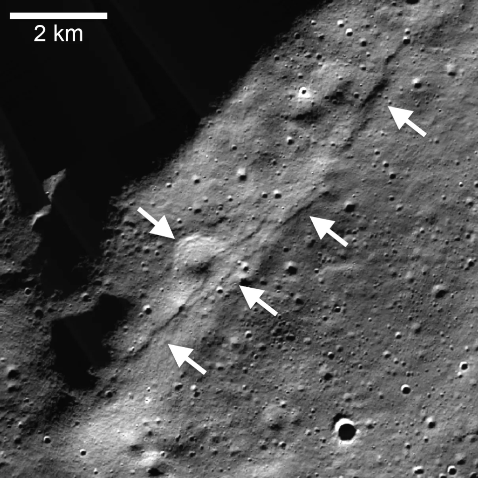 <em>Lunar Reconnaissance Orbiter Camera (LROC), Narrow Angle Camera (NAC) mosaic of the Wiechert cluster of lobate scarps (left pointing arrows) near the lunar south pole. A thrust fault scarp cut across an approximately 1-kilometer (0.6-mile) diameter degraded crater (right pointing arrow). CREDIT: NASA/LRO/LROC/ASU/Smithsonian Institution.</em>