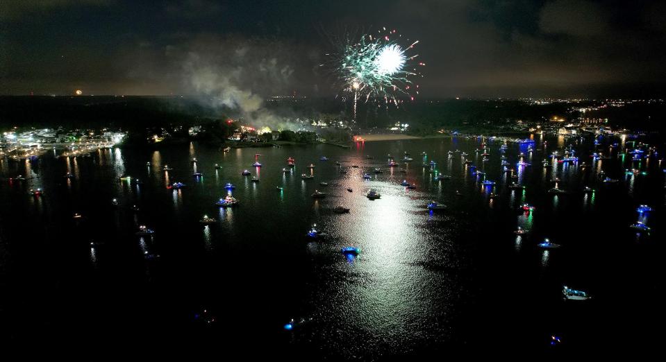 Fireworks launched from Windward Beach in Brick reflect off the Metedeconk River.