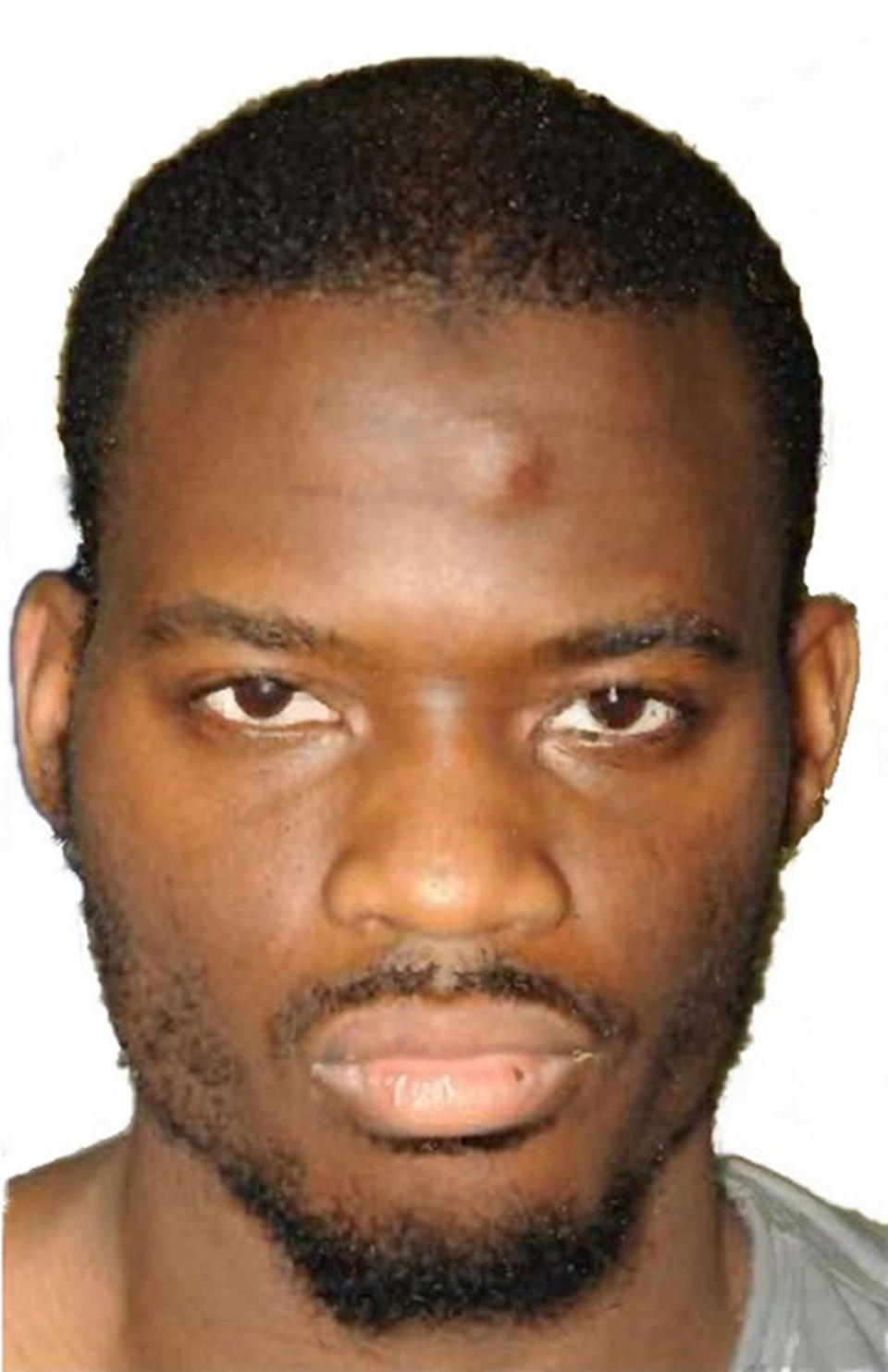 This is a an undated Metropolitan Police file handout photo of Michael Adebolajo  one of the two murderers of British soldier Lee Rigby who was killed in London in 2013.  Extremist Adebolajo who was convicted of fatally hacking British soldier Lee Rigby two years ago is suing prison officials over having his two front teeth knocked out. Michael Adebolajo seeks compensation for losing the teeth during a confrontation with prison personnel after his arrest but before his trial. (Metropolitan Police via AP)