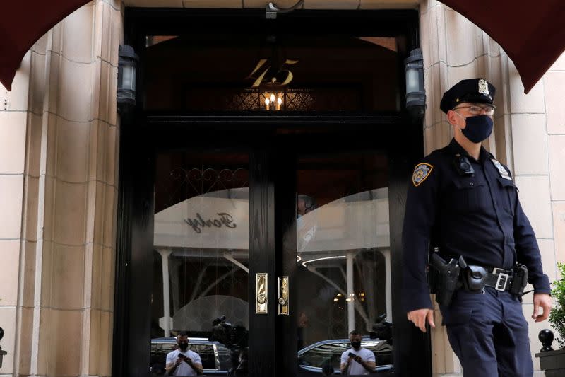 An officer from the New York Police Department (NYPD) exits the apartment building of Former New York City Mayor Rudy Giuliani, personal attorney to U.S. President Donald Trump, in Manhattan, New York City, New York
