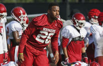 Oklahoma running back Kennedy Brooks warms up with teammates during an NCAA college football practice in Norman, Okla., Monday, Aug. 5, 2019. (AP Photo/Sue Ogrocki)