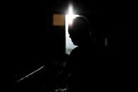 Sumitaka Haraguchi is silhouetted at his room of a nursing home where he lives during an interview with Reuters in Yokosuka, Japan September 11, 2018. Picture taken September 11, 2018. REUTERS/Kim Kyung-Hoon