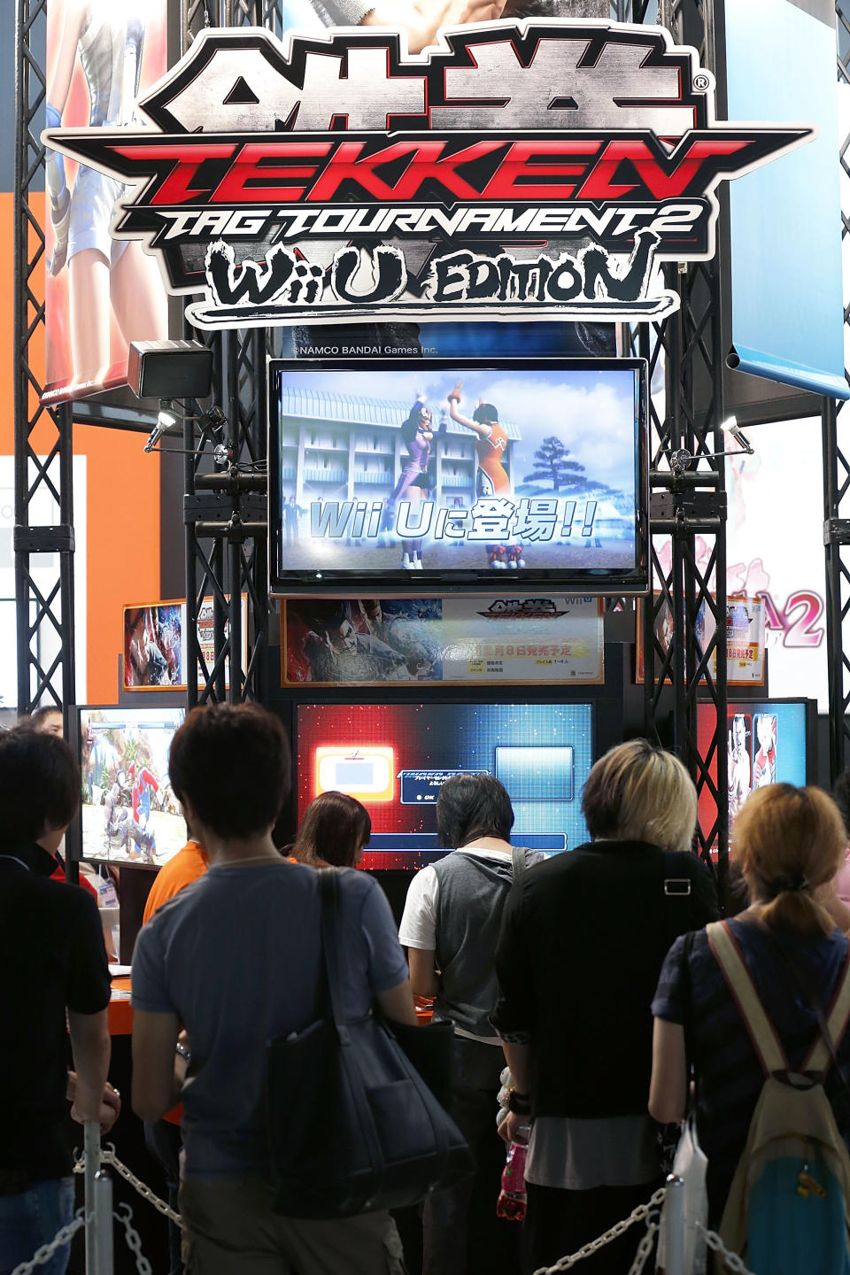 CHIBA, JAPAN - SEPTEMBER 20: Attendees wait in line to play Namco Bandai Games Inc.'s 'Tekken' with Nintendo Co.'s Wii U video game console during the Tokyo Game Show 2012 at Makuhari Messe on September 20, 2012 in Chiba, Japan. The annual video game expo, which is held from September 20 to 23, attracts thousands of business visitors and the general public with exhibitions of the upcoming game software and latest hardware. (Photo by Kiyoshi Ota/Getty Images)