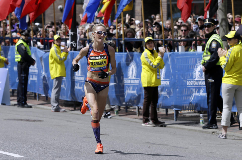 FILE - In this April 15, 2013, file photo, Shalane Flanagan approaches the finish line to finish fourth in the women's division of the Boston Marathon in Boston. Flanagan is more determined than ever to win the race for her battered hometown. The Marblehead, Mass., native would be the first American winner since 1985. (AP Photo/Elise Amendola, File)