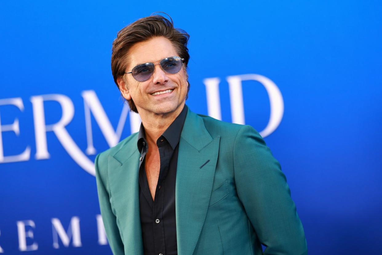 john stamos attends the world premiere of disneys the little mermaid