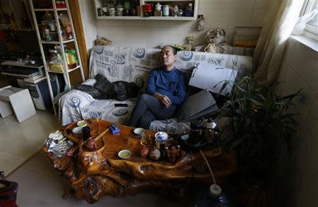 51 year-old Tian Lianpu, father of the late Tian Yao, born in August 1990 and died in January 2012 of lymphoma, pauses as he drinks tea at home in Beijing, December 26, 2013. REUTERS/Jason Lee