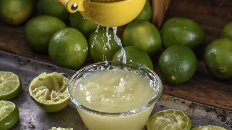 Limes being squeezed for juice