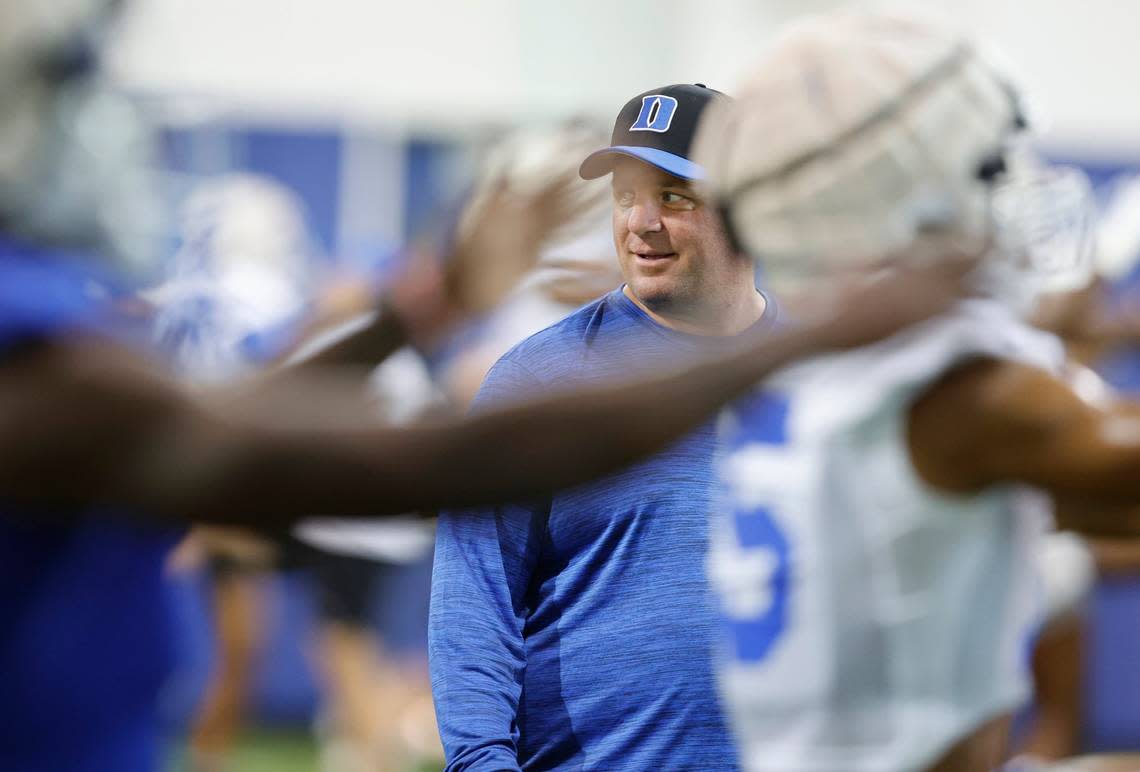 Duke head coach Mike Elko watches the team warmup during the Blue Devils first practice of fall camp in Durham. N.C. Tuesday, August 2, 2022.