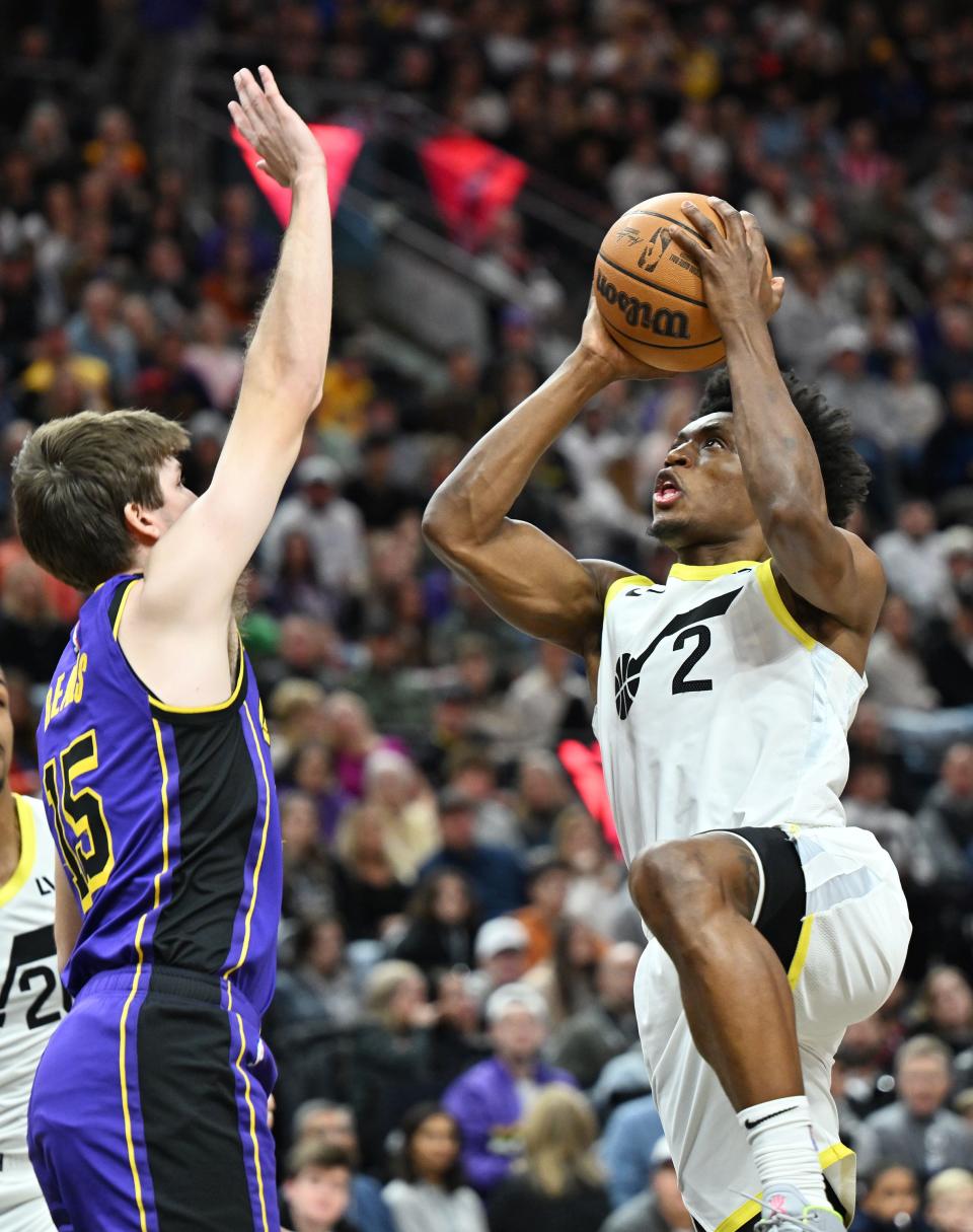 Utah Jazz guard Collin Sexton (2) goes up for a shot with Los Angeles Lakers guard Austin Reaves (15) defending him as Utah and Los Angeles play at the Delta Center in Salt Lake City on Saturday, Jan. 13, 2024. | Scott G Winterton, Deseret News