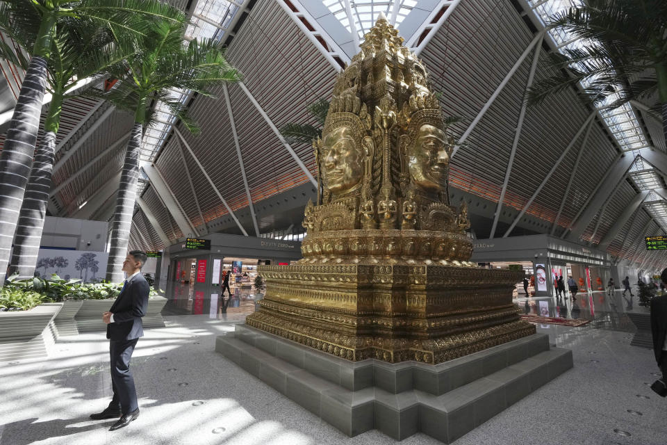 A Bayon carpet statue made of copper is displayed in the Siem Reap-Angkor International Airport in Cambodia as it opened Thursday, Nov. 16, 2023. Cambodia on Thursday officially inaugurated the country's newest and biggest airport, a Chinese-financed project meant to serve as an upgraded gateway to the country’s major tourist attraction, the centuries-old Angkor Wat temple complex in the northwestern province of Siem Reap. (AP Photo/Heng Sinith)