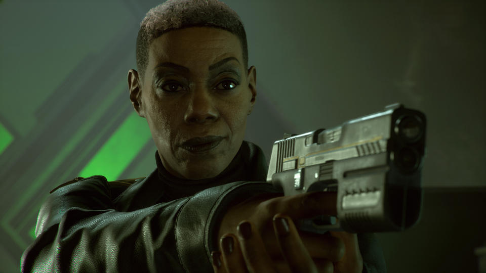 Amanda Waller points a gun towards the camera