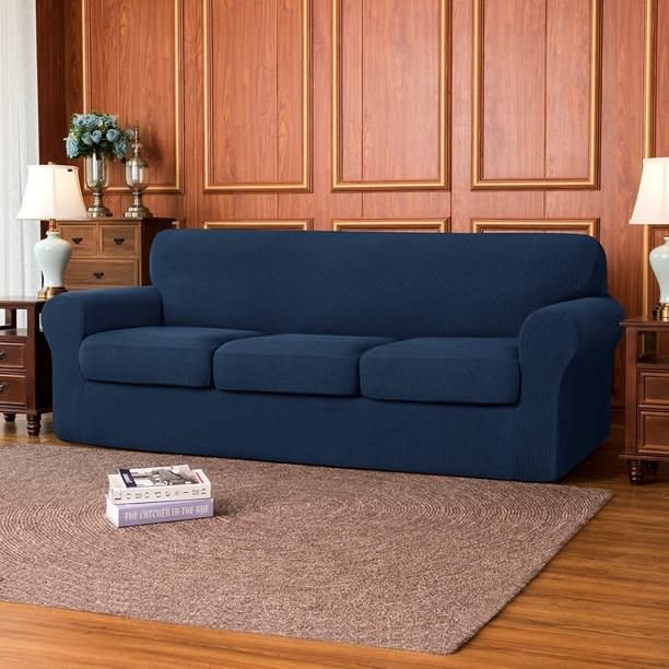 The slipcover on a couch in the navy color