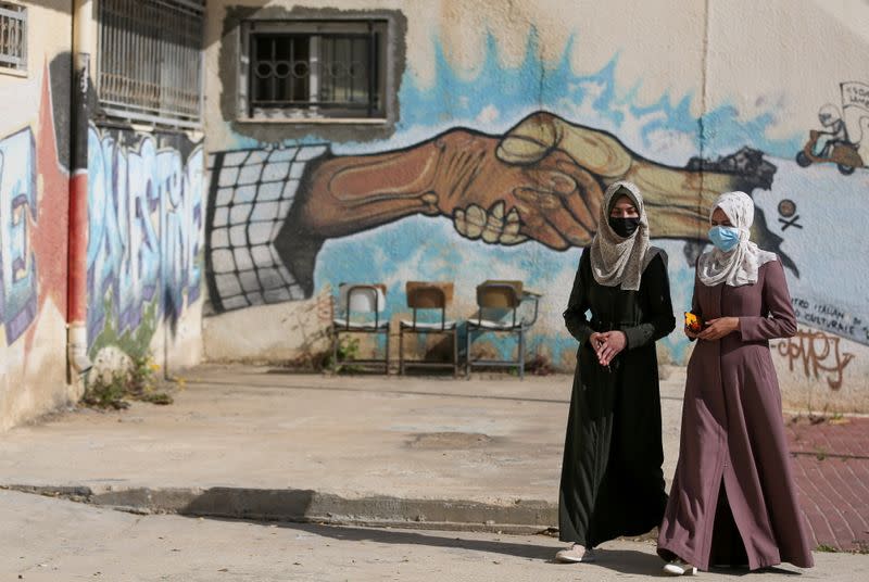 Palestinian students walk at a university in Khan Younis in the southern Gaza Strip