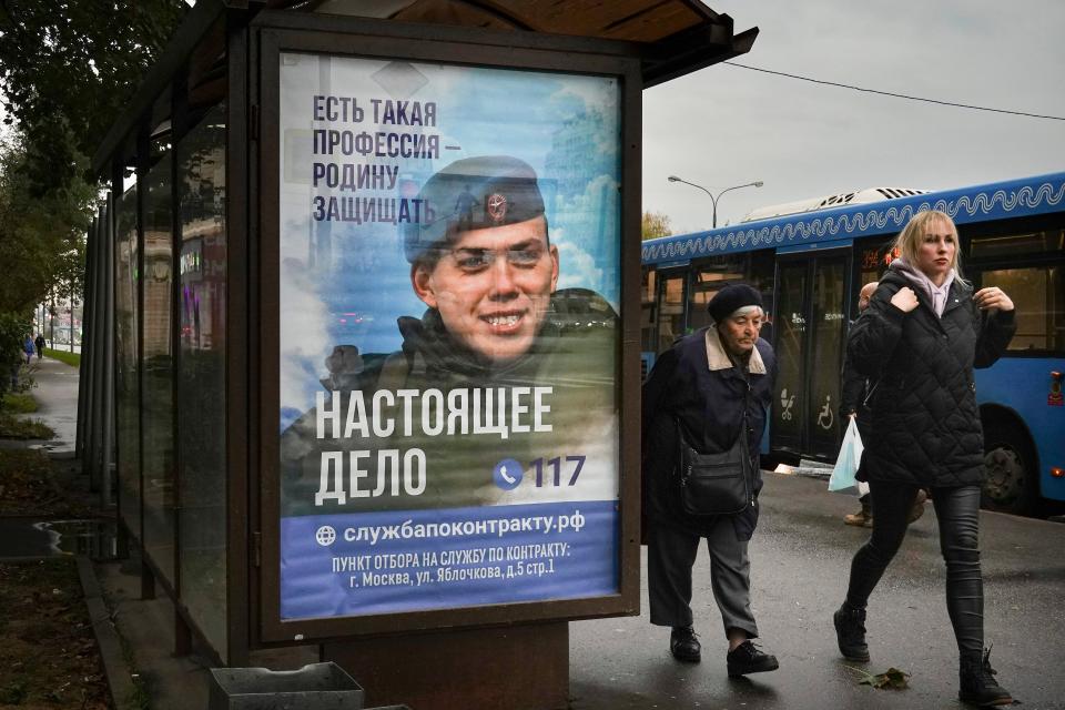 A bus stop with an advertising poster for military conscription, showing a Russian soldier with the slogan 'There is such a profession as defending the homeland. The real deal.', in Moscow (EPA)