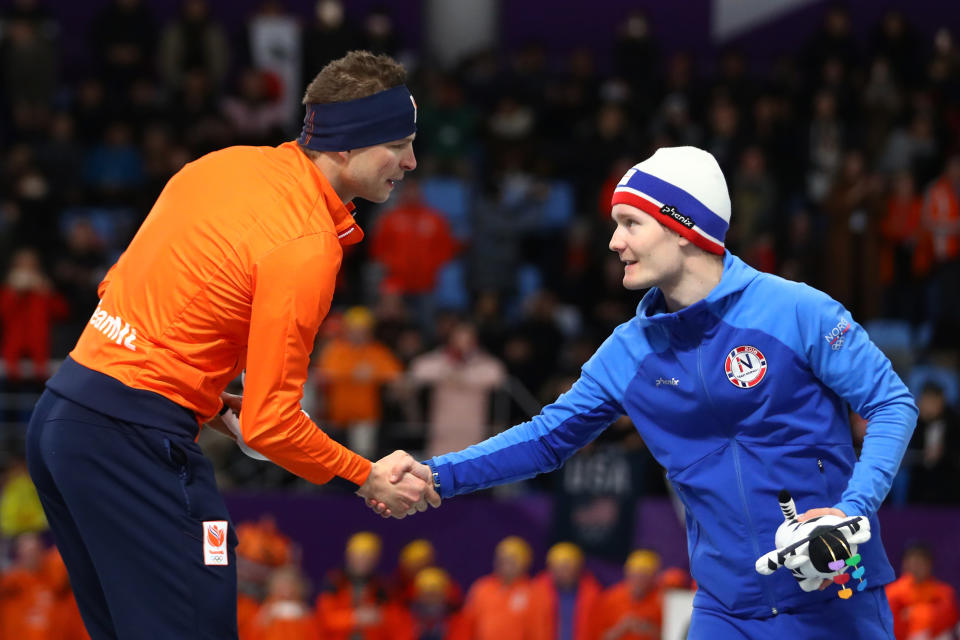 Gold medalist Sven Kramer of the Netherlands and bronze medalist Sverre Lunde Pedersen of Norway shake hands during the victory ceremony after the Men’s 5000m Speed Skating event. (Getty)