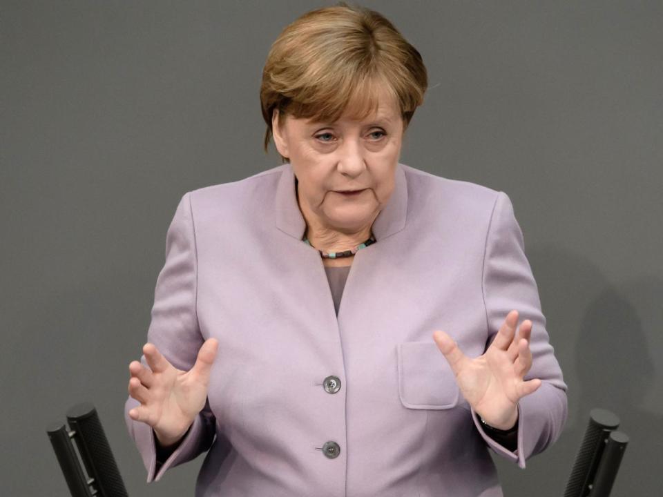 Angela Merkel addressing the Bundestag in Berlin on 27 April (EPA)
