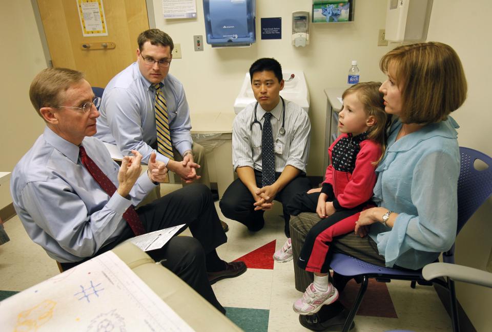 Dr. Wesley Burks MD, left, speaks with 4 year-old Ashlyn Chadwick and her mother Karen about Ashlyn's peanut allergies during a clinic at the Duke South Clinic at Duke University in Durham, N.C., Tuesday, March 10, 2009. Medical student Sean Prater looks on along with Dr. Edwin Kim, center. A handful of children once severely allergic to peanuts now can eat them without worry. Scientists have retrained their immune systems so they're allergy-free (AP Photo/Gerry Broome)