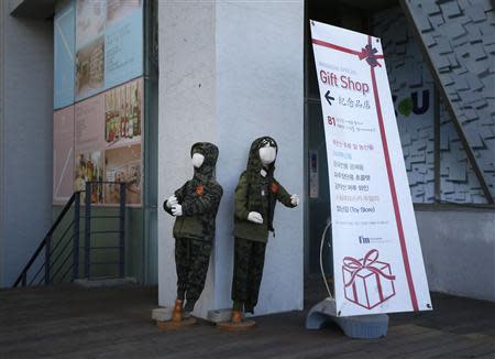 Military uniforms for children are displayed at the Imjingak pavilion near the demilitarized zone which separates the two Koreas, in Paju, north of Seoul October 16, 2013. REUTERS/Kim Hong-Ji