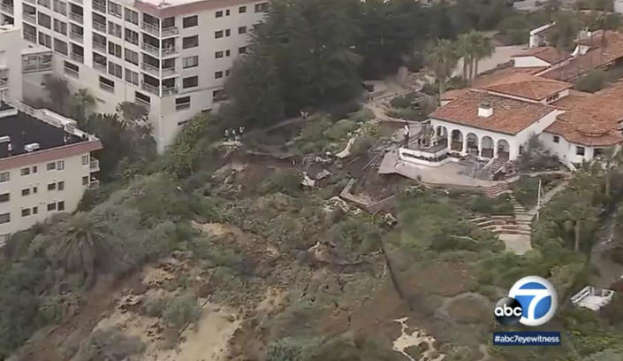 In this image from KABC7 video, is an aerial view of a landslide on the western side of the Casa Romantica and Cultural Center and Gardens in San Clemente, Calif., on Thursday, April 27, 2023. The landslide in Southern California has closed the historic cultural center, shut down rail service in the area and forced the evacuation of nearby residences, officials said. The slope on the hillside dropped about 20 feet (about 6 meters) after several days of minor earth movement. (KABC7 via AP)