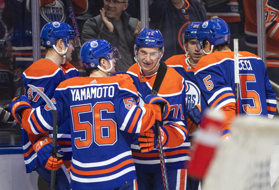 Edmonton Oilers' Ryan McLeod (71) celebrates with teammates after his goal against the Calgary Flames during the second period of an NHL hockey game Saturday, Oct. 15, 2022, in Edmonton, Alberta. (Jason Franson/The Canadian Press via AP)