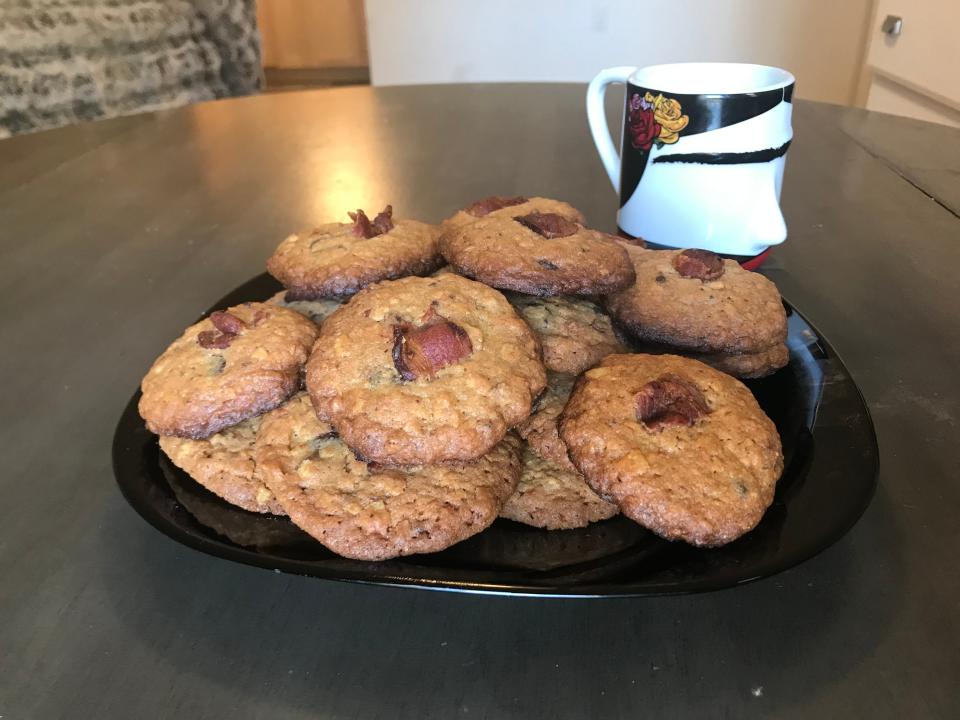 Martha Stewart's Bacon Potato-Chip Chocolate Cookies positioned on a black plate after being removed from the oven.