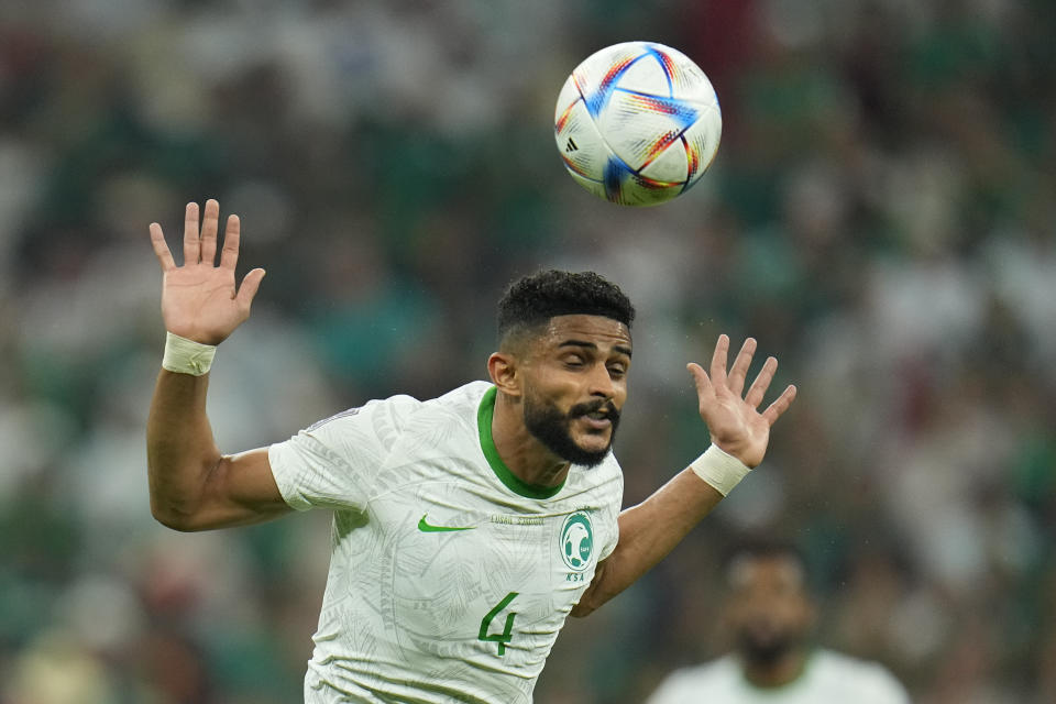 Saudi Arabia's Abdulelah Al-Amri heads the ball during the World Cup group C soccer match between Saudi Arabia and Mexico, at the Lusail Stadium in Lusail, Qatar, Wednesday, Nov. 30, 2022. (AP Photo/Julio Cortez)