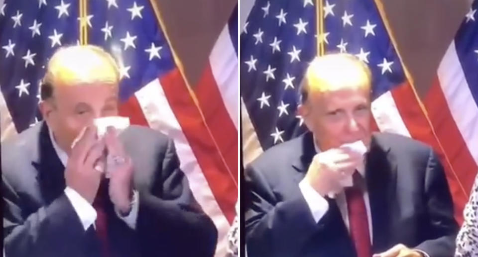 Rudy Giuliani blows his nose with a handkerchief before wiping his mouth and face with it.